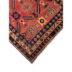 Near pair of Persian Azerbaijan red ground runners, each rug decorated with Nazarlik and stylised leaf motifs, enclosed with three band border decorated with flower heads and geometric motifs 

406cm x 99cm 
409cm x 102cm
