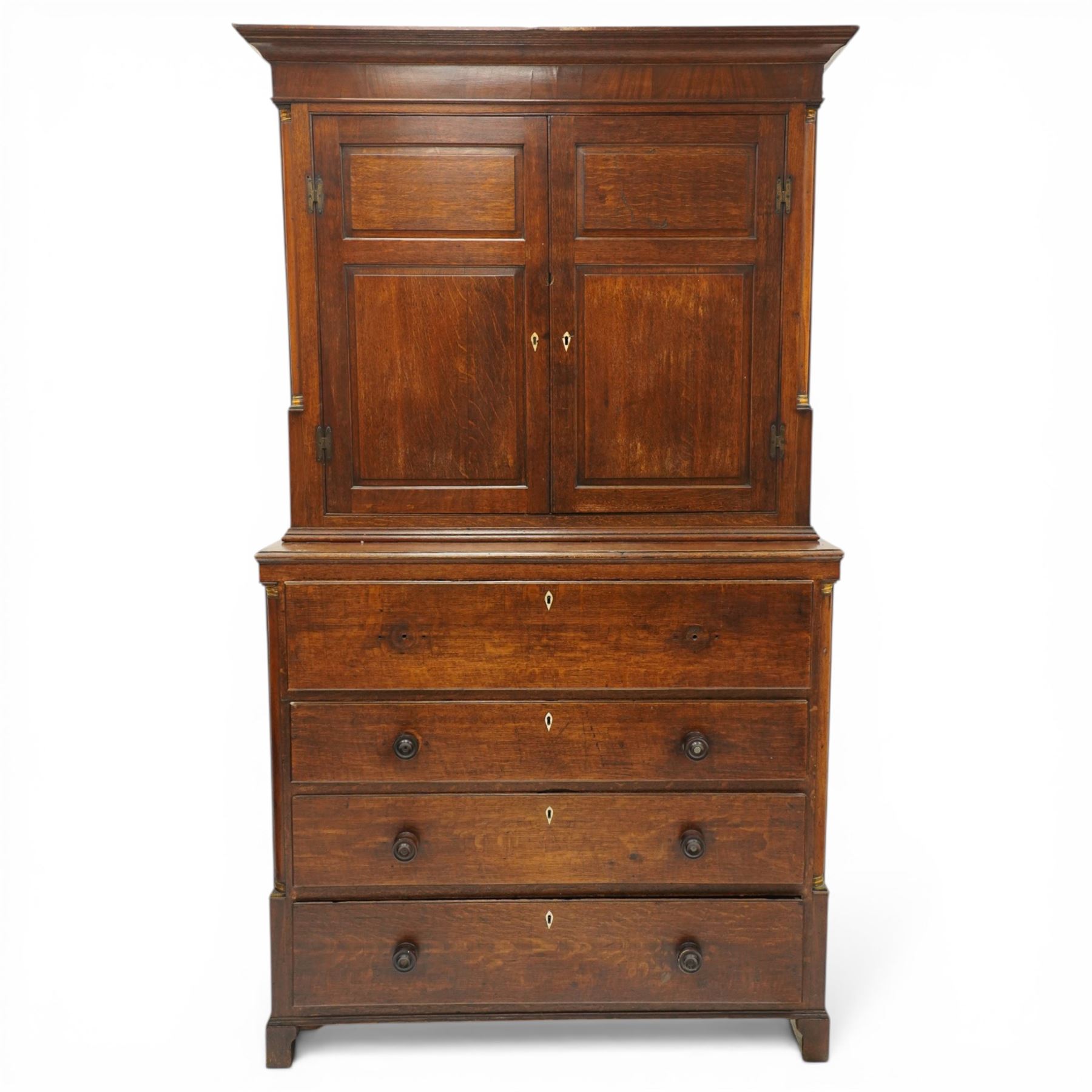 George III oak and mahogany bound enclosed bookcase-secretaire, panelled cupboards over four drawers