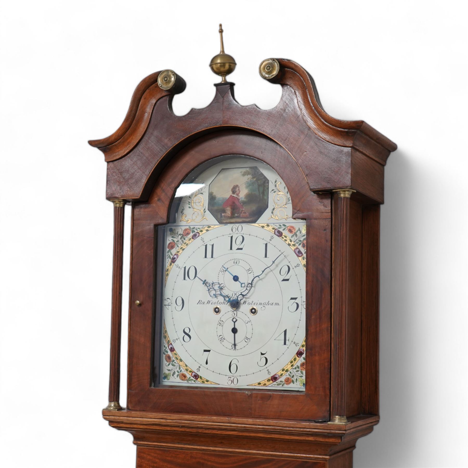 Ralph Weston (III) of Wolsingham (Co Durham) - 30-hour oak and mahogany longcase clock c1815-17, With a swan necked pediment, brass parterre and central spire finial, break arch hood door beneath flanked by reeded pilasters with brass capitals, trunk with recessed reeded pilasters and a crossbanded door with a concave top, square plinth on bracket feet, painted dial with floral depiction to the spandrels and a depiction of a boy attempting to catch birds in the arch, with makers name, Roman numerals, five minute Arabic's, minute track and matching steel hands, with dummy seconds and calendar dials and dummy winding arbors, dial pinned via a cast falseplate by Whittaker & Shreeve to a countwheel striking chain driven movement striking the hours on a bell. With weight and pendulum.
Notes.
The Weston family were a prodigious three generation family of 18th and 19th century Wolsingham clockmakers, all christened Ralph. The maker of this clock Ralph (III) frequently made 30hr clocks such as this possessing features normally found on  8-day clock dials.
Both the clockmaker, clock and dial were the subject of a comprehensive five part article in CLOCKS magazine published between  Nov 2012 and March 2013. The dial of the clock being of particular interest, manufactured by the Haifax firm of Shreve and Whittaker between 1815-17 . 
William Shreeve, a highly respected and competent dial painter went into a short-lived partnership with William Whittaker in 1815, however in 1817 Shreeve died in a tragic accident whereby he was burnt to death whilst preparing some of his own paints and varnishes. 

