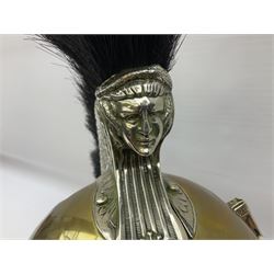 Early 20th century French mounted gendarme's helmet, brass with nickel-silver mountings, broad band embossed with fused grenade, high comb with the face of the gorgon Medusa at the peak and with a black horse hair crest, plume socket at the left, leather-backed nickel-silver chin scales with lion mask mounts.