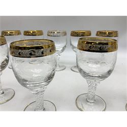 Set of twelve Moser style wine glasses, the bowls with etched floral bodies and gold banded rim with foliate decoration raised upon stem of twisted form, H14cm