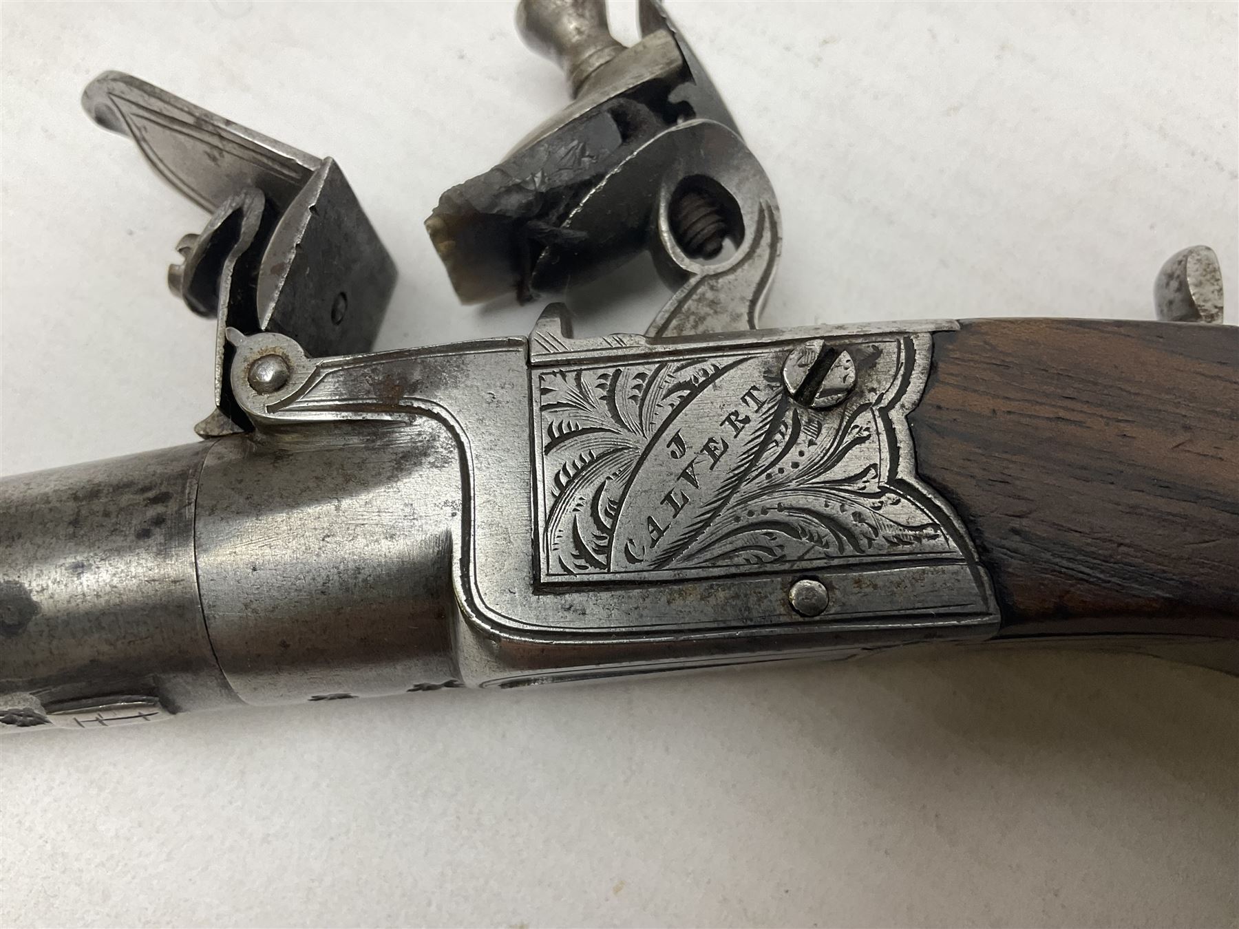 Early 19th century J. Calvert (Leeds) flintlock single barrel tap action pocket pistol, approximately .45 cal., the 4cm (originally) screw off barrel with top safety and walnut stock L16cm overall