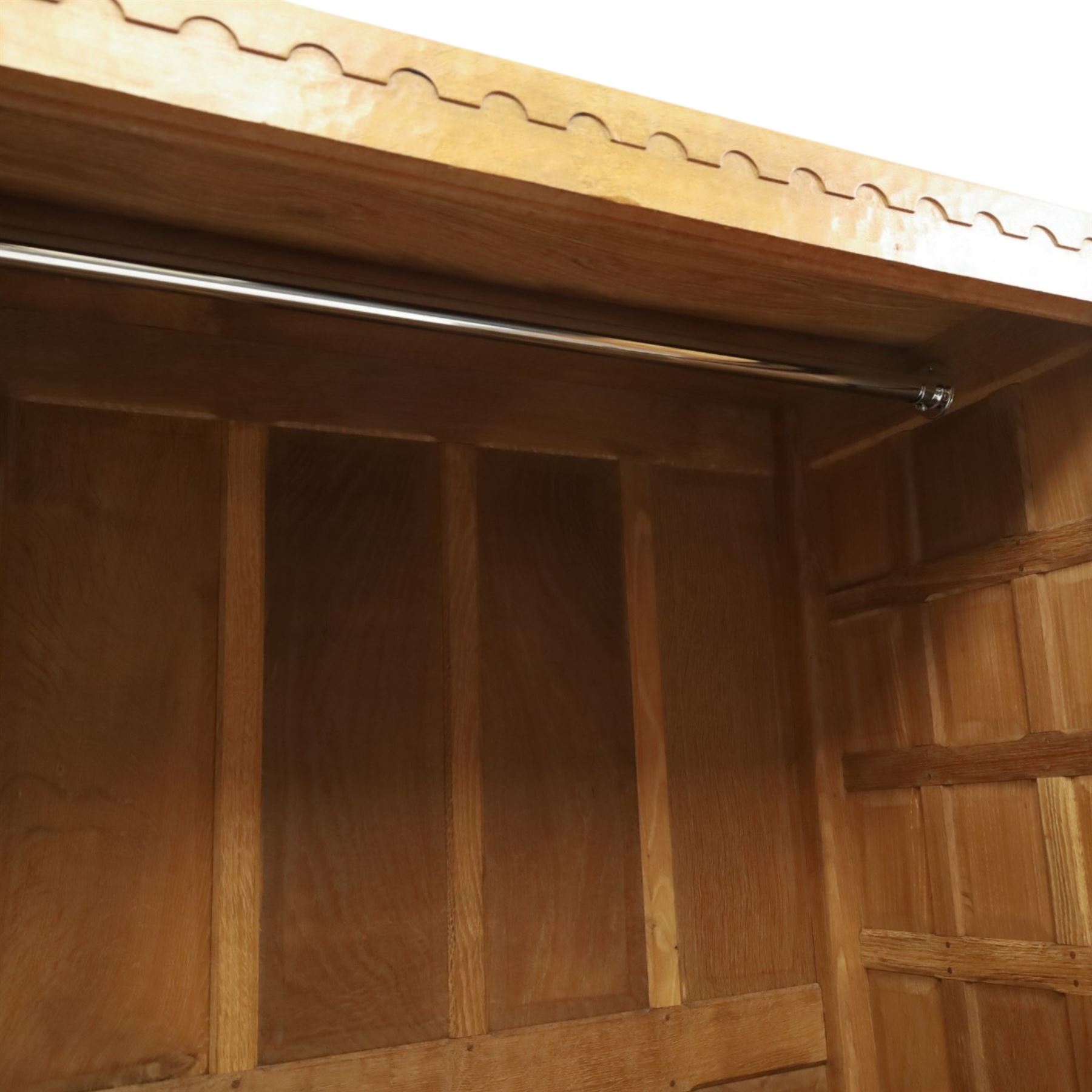 Mouseman - early-to-mid-20th century panelled and adzed double wardrobe, the arcade carved cresting rail over two panelled doors, with wrought metal hinges and latch, deep relief carved mouse signature, the interior fitted with hanging rail, by the workshop of Robert Thompson of Kilburn