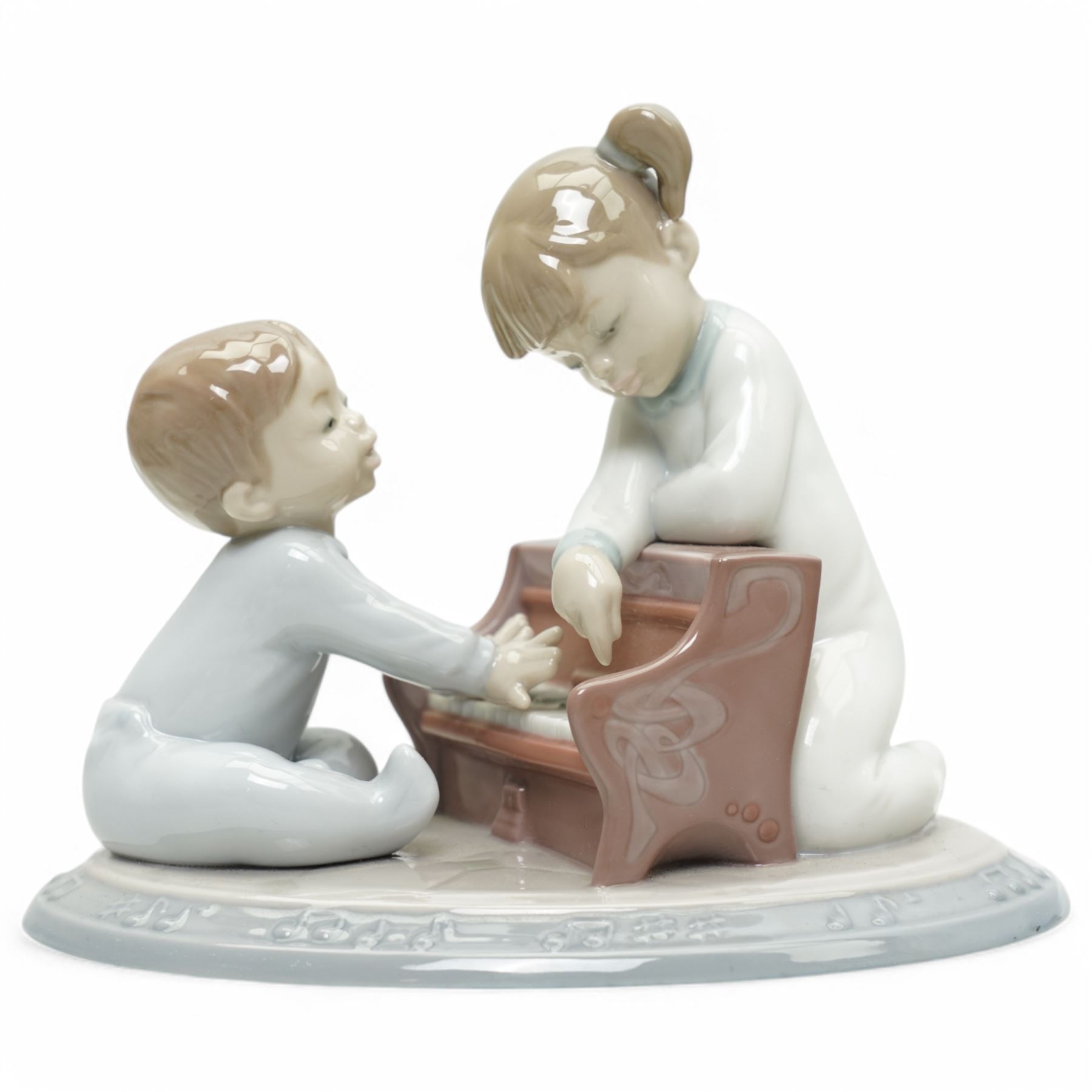 Two Lladro figures, comprising First Melodies 6475 and Happy Anniversary 8292, with one Nadal ballerina, all boxed, tallest H31cm excluding base (3)