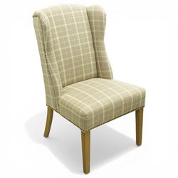 Contemporary wing back dining chair, fully upholstered in beige plaid fabric with studded ...
