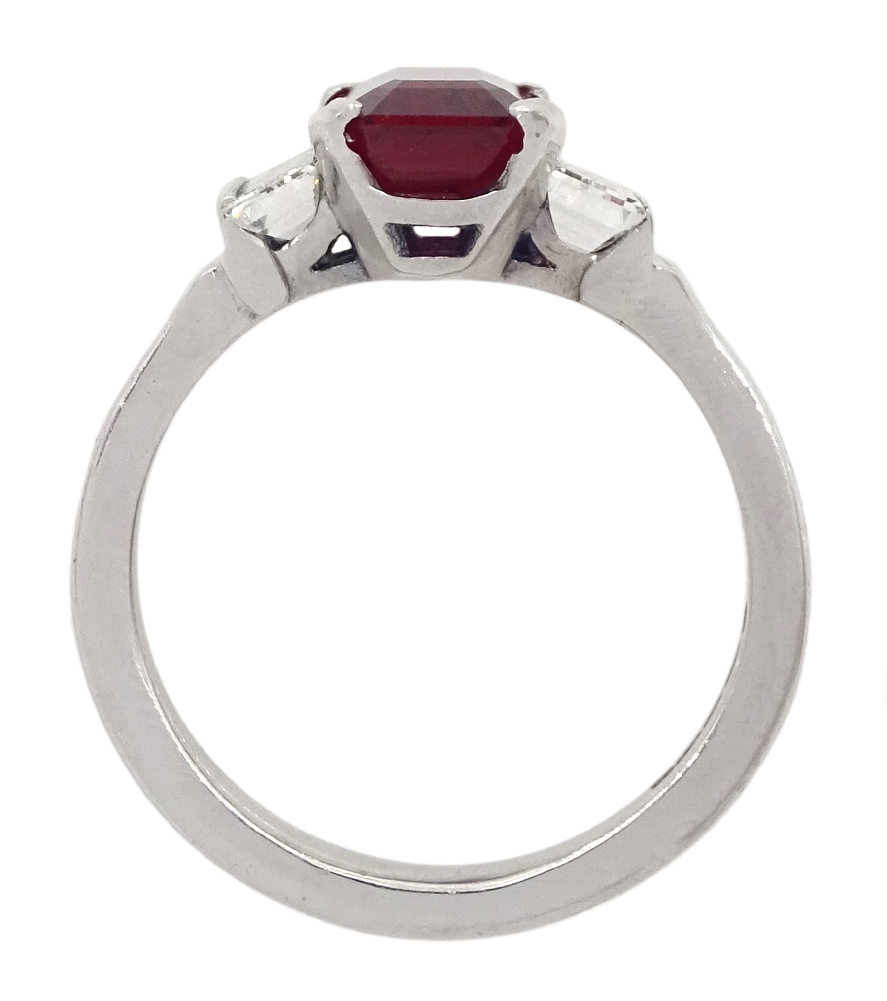18ct white gold ruby and diamond three stone ring, single emerald cut Thai ruby of approx 2.00 carat, with a baguette cut diamond set either side, hallmarked, total diamond weight approx 0.60 carat