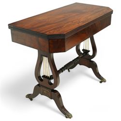 Regency mahogany and ebony inlaid fold-over tea table with reeded edge above spiral reeded centre stretcher on lyre supports with brass star inlaid panel on out swept legs with lion paw brass castors 