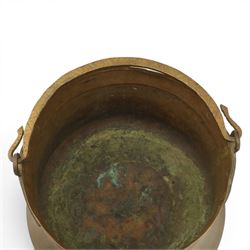 19th century brass and copper cauldron, circular open body with rolled rim, riveted side mounts and swing carrying handle, on broad flared circular foot