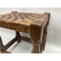 Yorkshire Oak - small oak stool, leather latticework seat on octagonal supports united by stretchers, the front stretcher carved with Yorkshire Rose motif