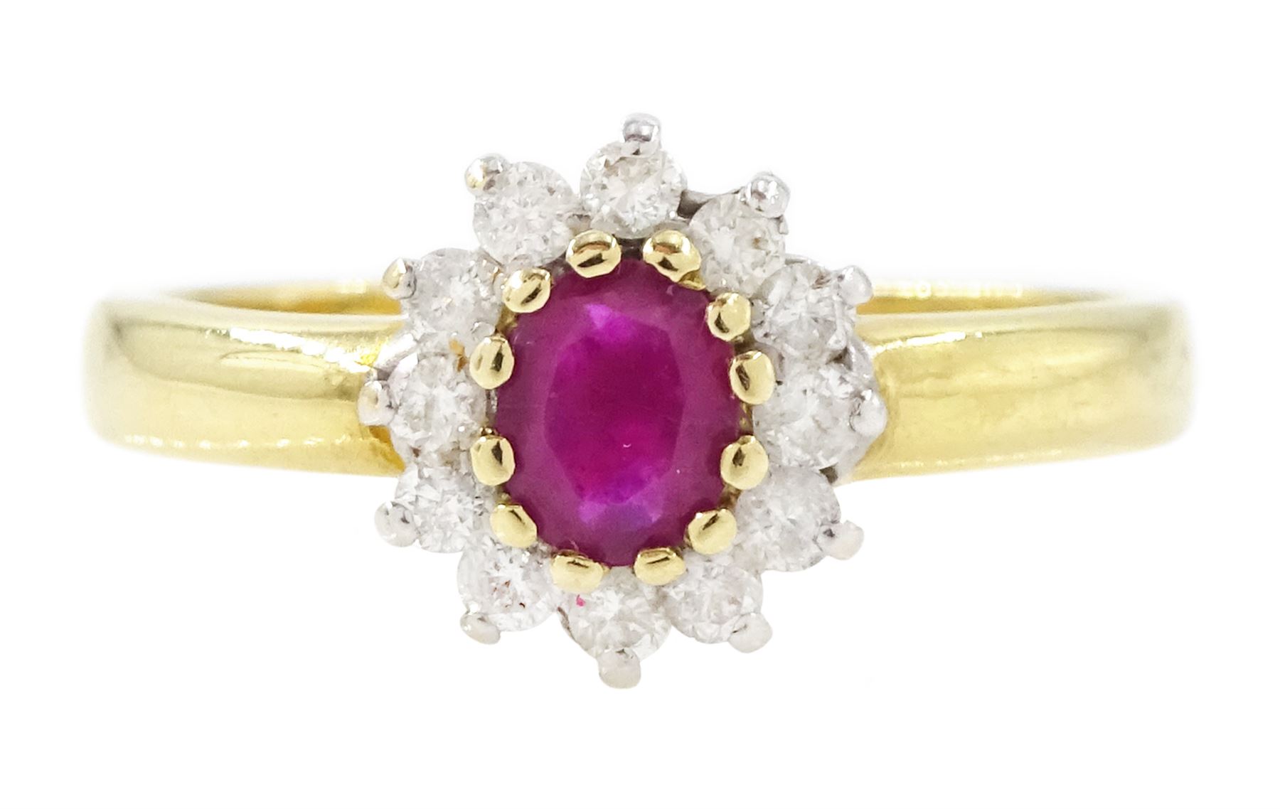 18ct gold ruby and diamond cluster ring, single oval cut ruby of approx 0.25 carat, surrounded by twelve round brilliant cut diamonds, hallmarked, total diamond weight 0.25 carat