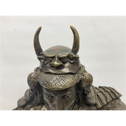 Bronze figure of a samurai standing wearing armour and holding a naginata, upon a rocky base, H48cm