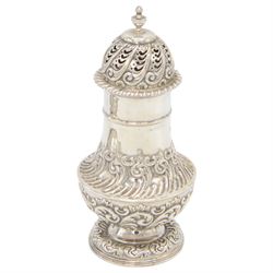 Late Victorian silver sugar caster, of typical waisted form, with embossed scrolling and foliate decoration and urn finial to removable pierced cover, upon circular foot, hallmarked Fenton Brothers, Sheffield 1895, H19cm
