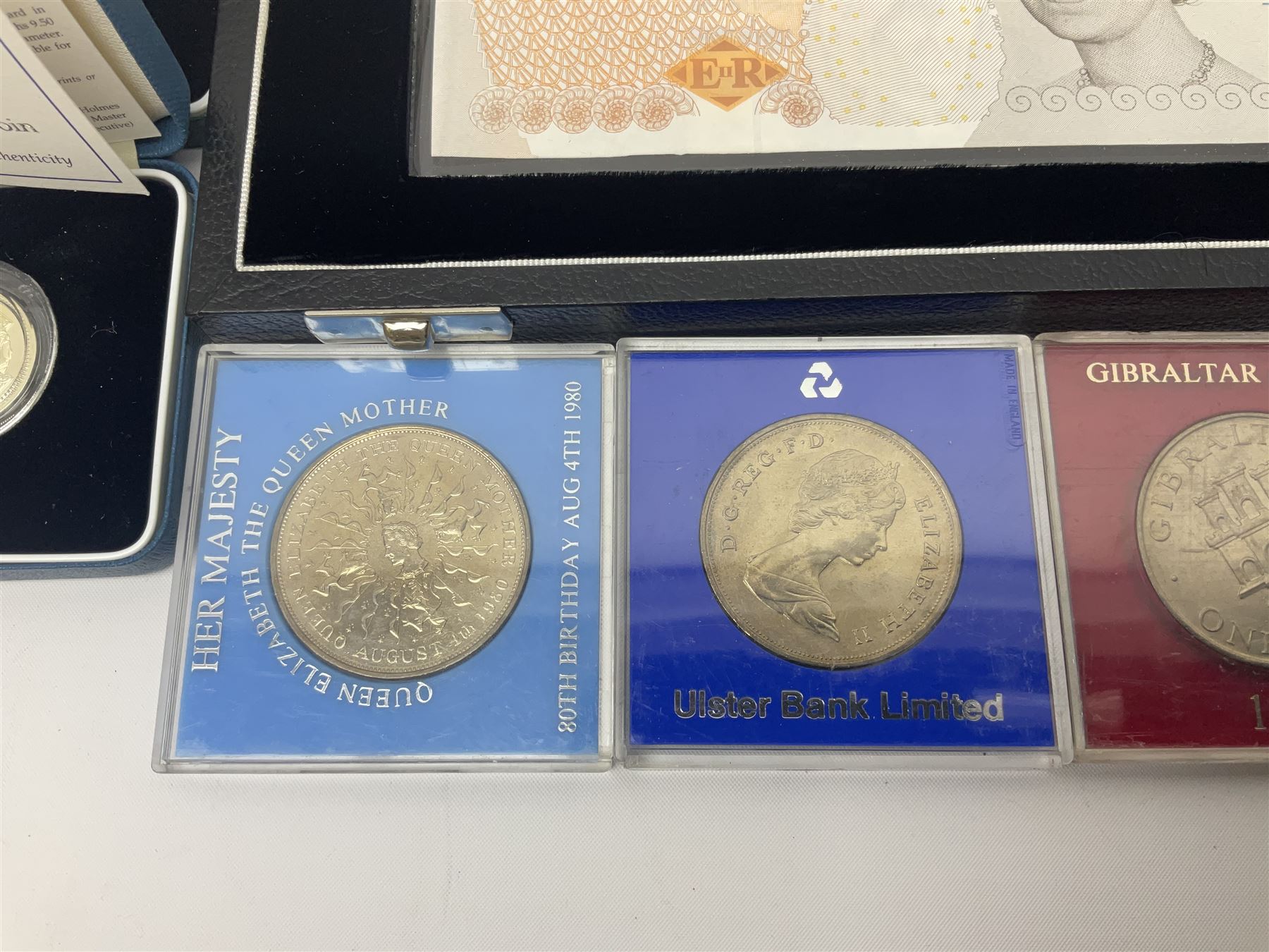The Royal Mint United Kingdom 'Millennium' silver proof two coin set comprising 1999 and 2000 five pound coins, 2000 'The Queen Mother Centenary Year' silver proof crown, 2001silver proof one pound, 'Her Majesty The Queen Golden Jubilee 1952-2002' silver proof 2002 five pound coin and ten pound banknote set, all being cased with certificates, United Kingdom 1999 brilliant uncirculated coin collection in card folder, other commemorative coinage etc