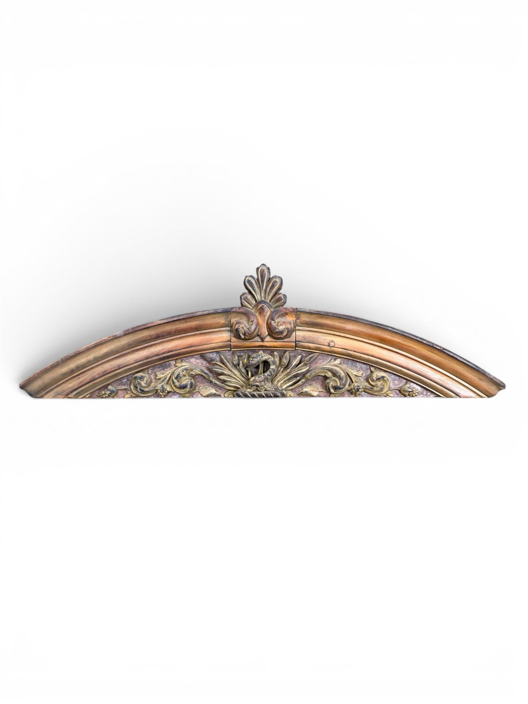 19th century carved pine architectural pediment, detailing floral swags with berries and central serpentine snake head 