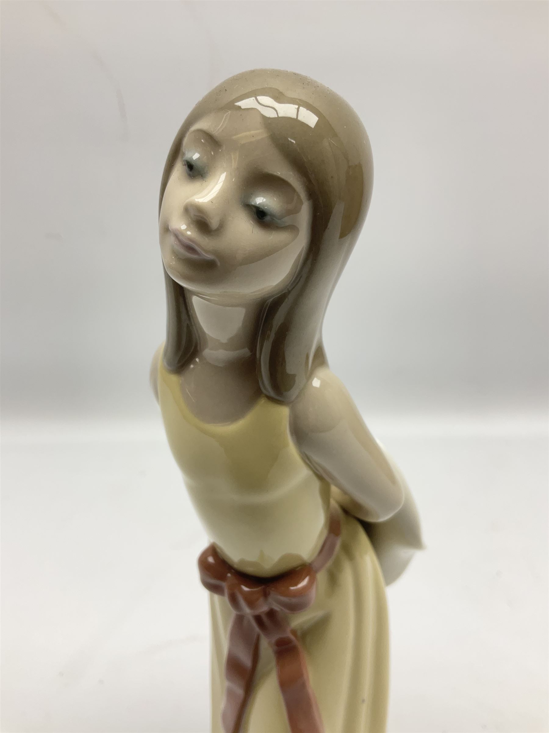 Three Lladro figures, comprising Little Jester no 5203, Pals Forever no 7686 and Naughty Girl no 5006, H25cm