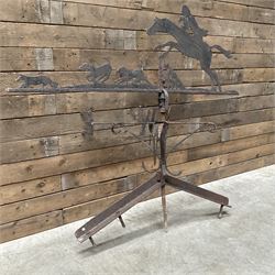 Black painted wrought iron weather-vane depicting hunting scene and compass points
