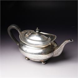 Silver tea pot of oval form with ebonised handle and lift on compressed bun feet Sheffield...