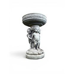 Cast stone cherub bird bath, circular removable top raised on three cherubs with ornate detailing