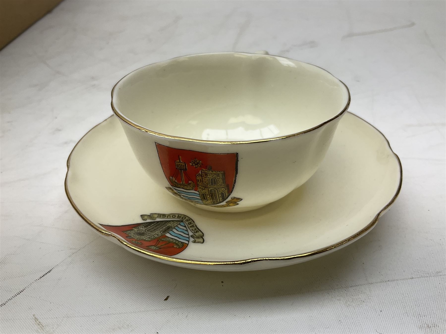 Collection of W H Goss crested ware, to include Yorkshire Roman Ewer, Scarborough ancient jug, salt and pepper shakers, Norwegian horse shaped beer bowl, The Old Horse Shoe, etc, together with five Shelley examples modelled as piano, boat, heart shaped box, etc, in two boxes 