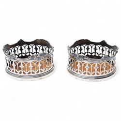  Pair of Victorian plated bottle coasters with pierced sides and turned boxwood bases
