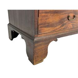 George III mahogany linen press, projecting cornice over two figured doors enclosing five linen slides, the lower section fitted with two short and two long drawers, on bracket feet