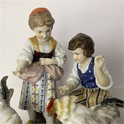 Two 19th century german figures, each modelled as children feeding birds, H19cm 