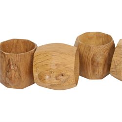 Mouseman - four light oak napkin rings, of bulbous octagonal form with signature mouse carving by Robert Thompson of Kilburn