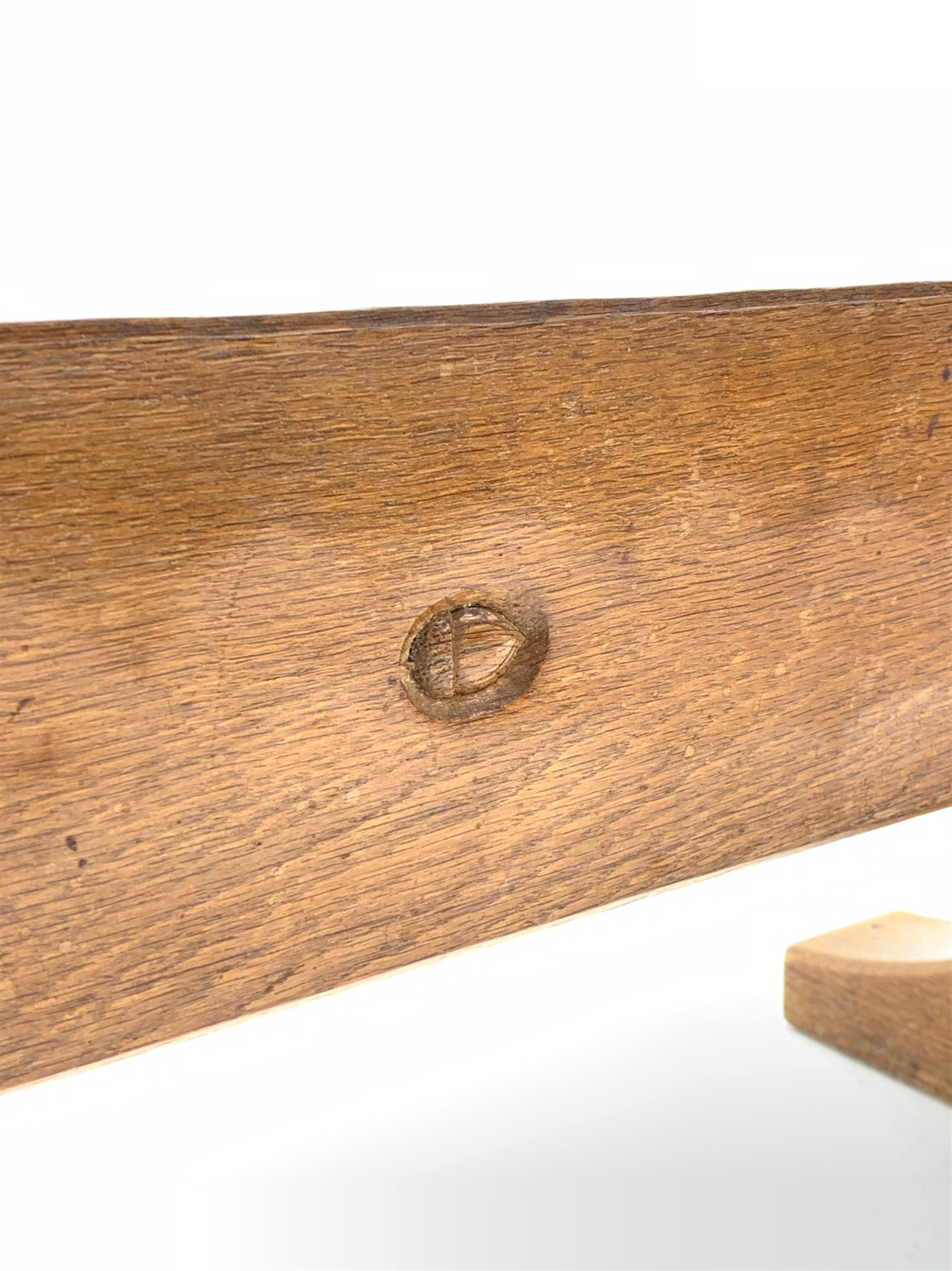 'Acornman' oak table with rectangular adzed top, shaped end supports on sledge feet joined by pegged stretcher carved with acorn signature, by Alan Grainger of Brandsby, York