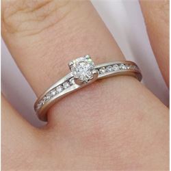 Platinum single stone round brilliant cut diamond ring, with channel set diamond shoulders, hallmarked, central diamond approx 0.25 carat