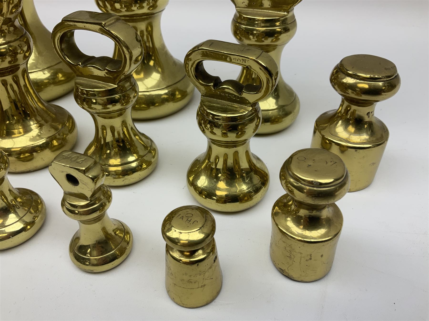 Graduated set of eight brass bell weights, together with a set of five graduating weights (13)