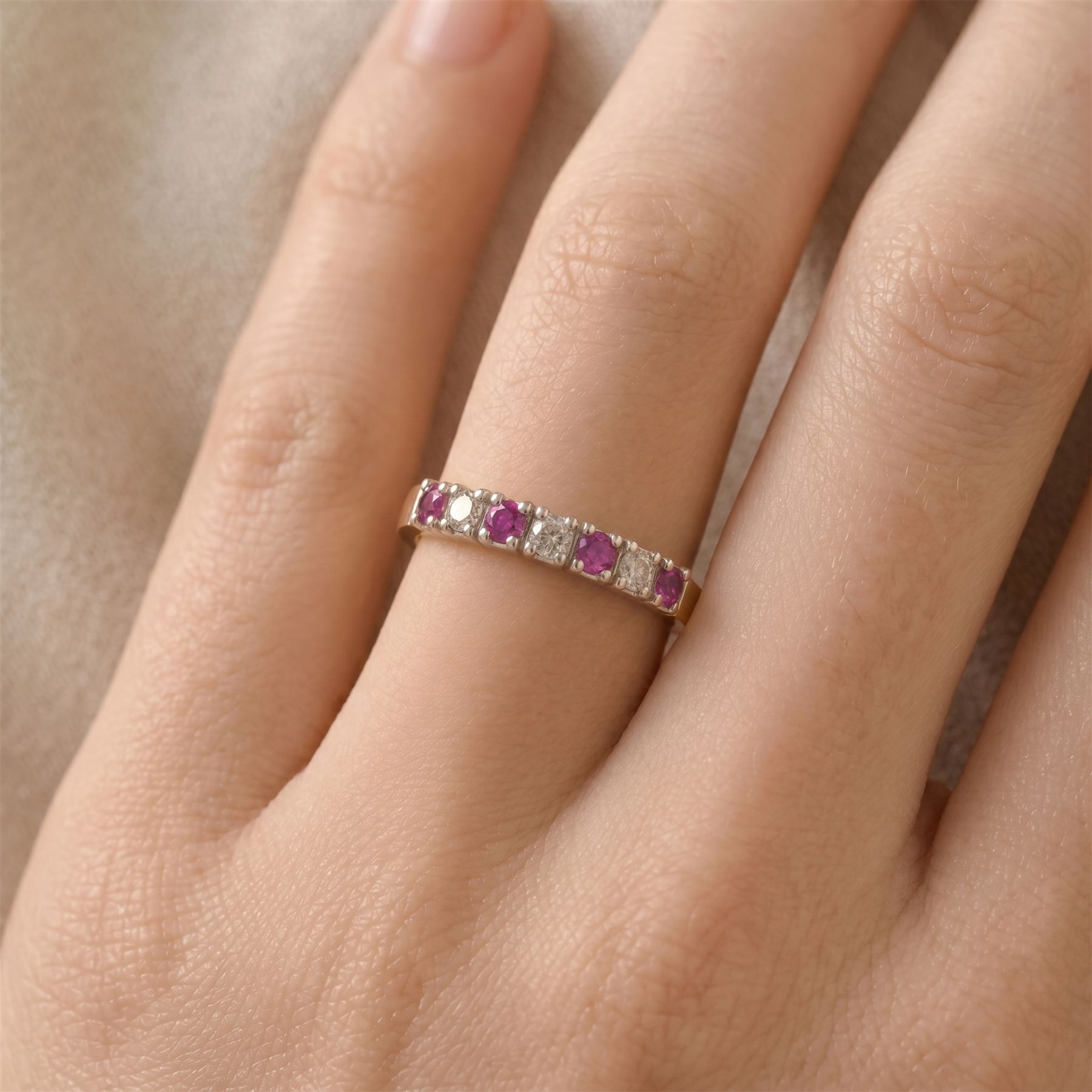 9ct gold ruby and diamond seven stone half eternity ring, alternate set with round brilliant cut diamonds and rubies, hallmarked, total diamond weight 0.15 carat