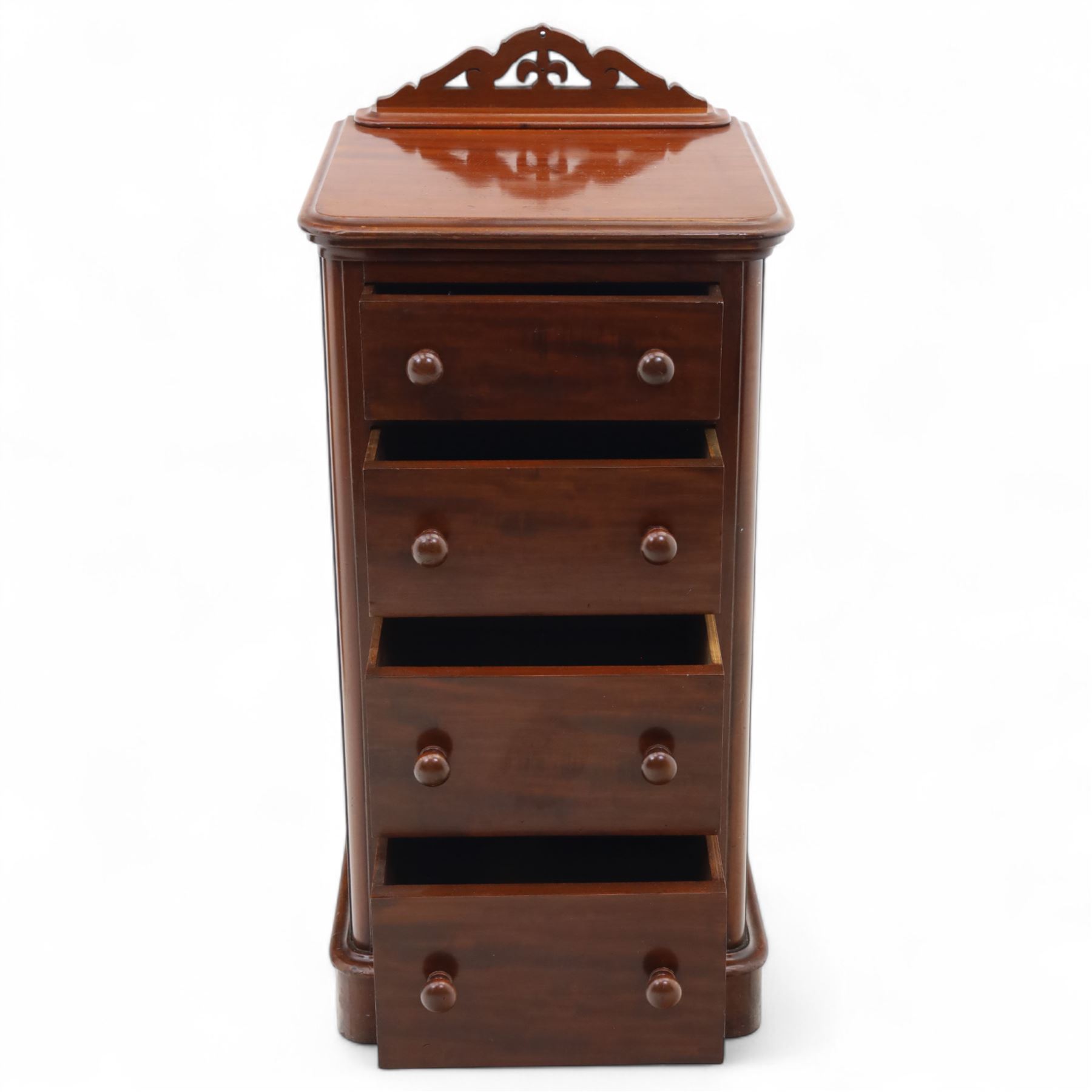 Pair of tall Victorian mahogany bedside chests, of narrow upright form, rectangular top with moulded edge, the back with raised pierced fretwork gallery, above four graduated drawers with knob handles, raised on a plinth base 
