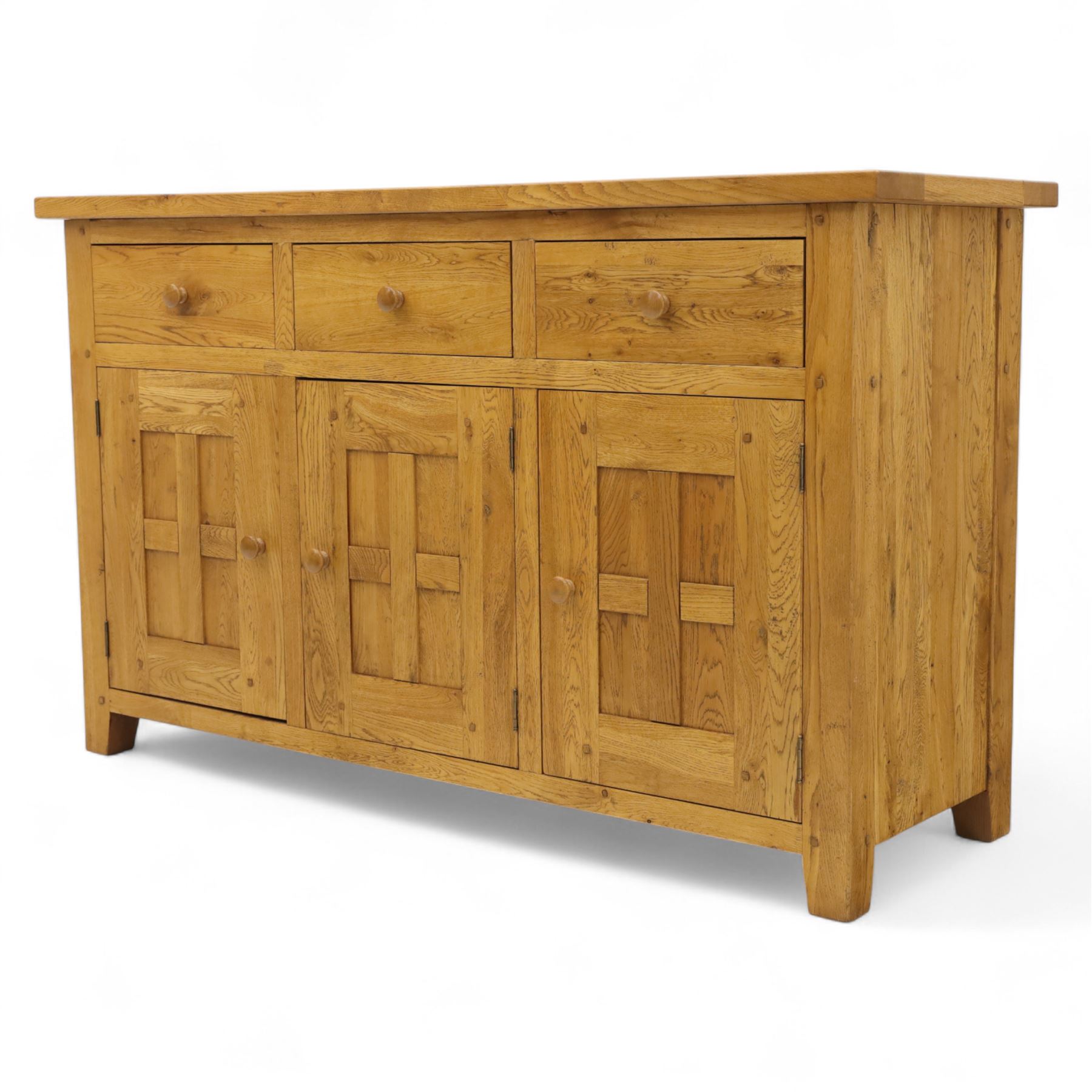 Contemporary solid oak sideboard, rectangular plank top above three drawers and three panelled cupboard doors, fitted with wooden knop handles