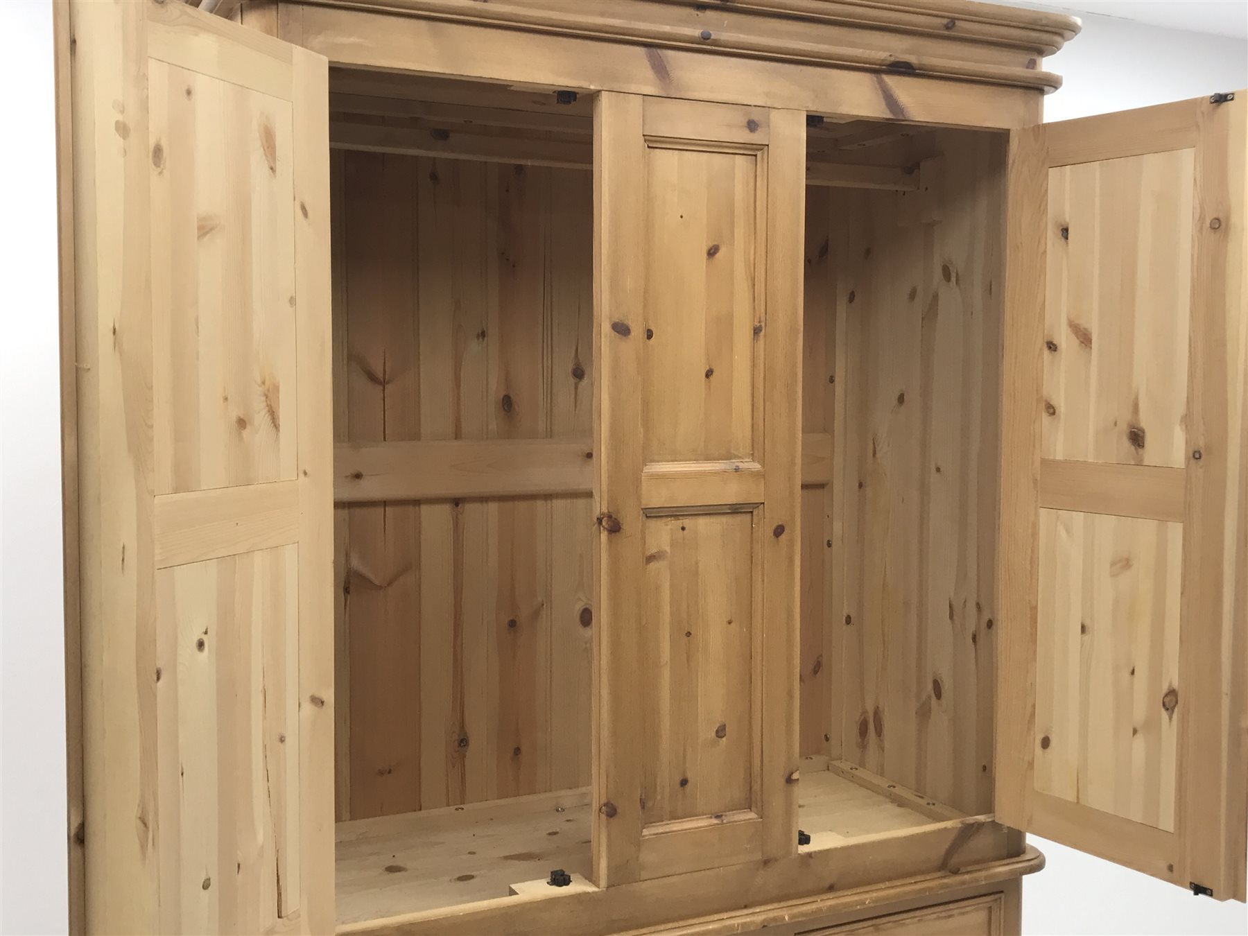 Waxed pine wardrobe enclosed by two panelled doors on chest fitted with