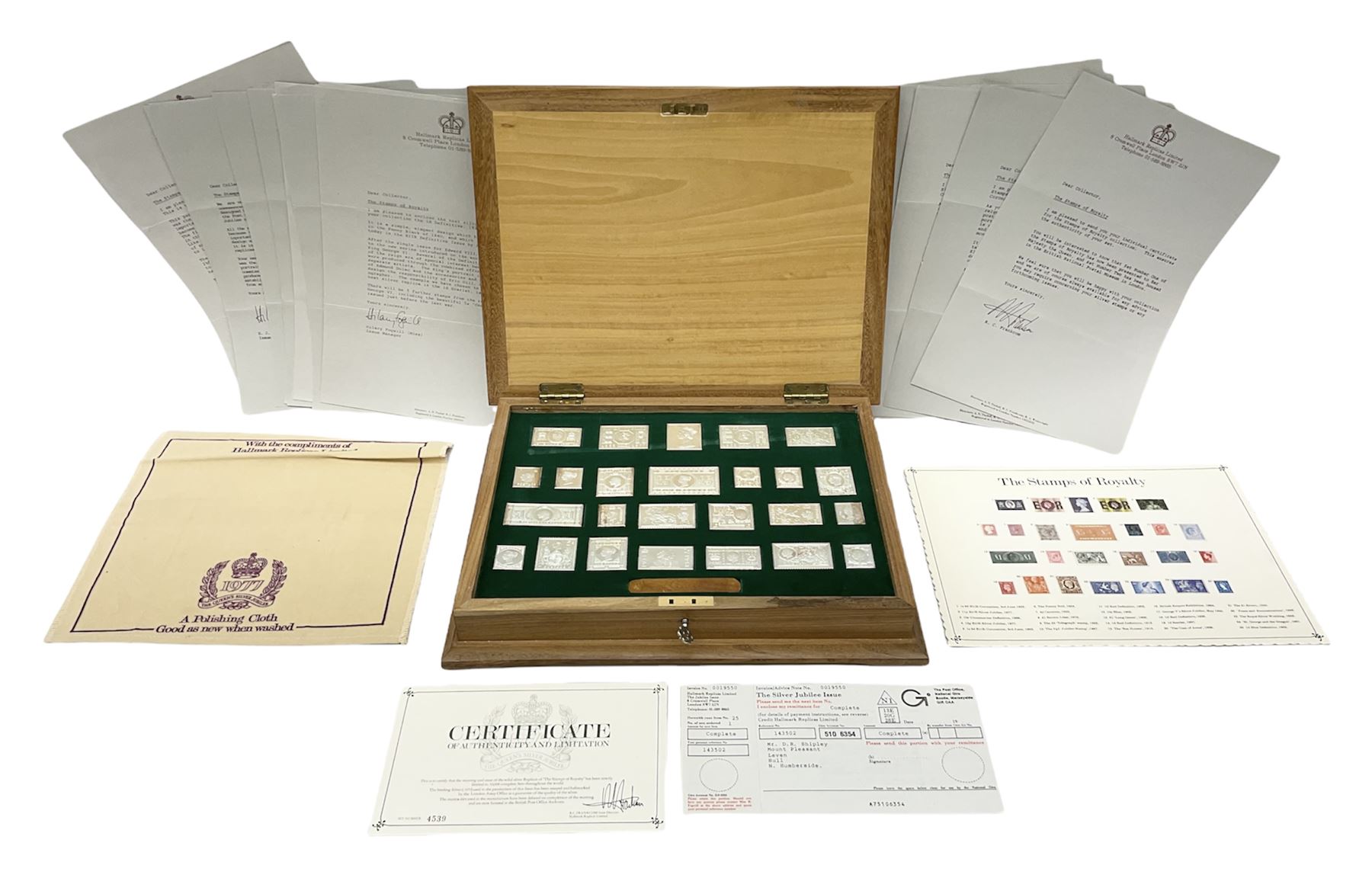 The Stamps of Royalty collection consisting of twenty-five sterling silver hallmarked stamp replicas, housed in a fitted wooden display case, with certificates, polishing cloth and certificates