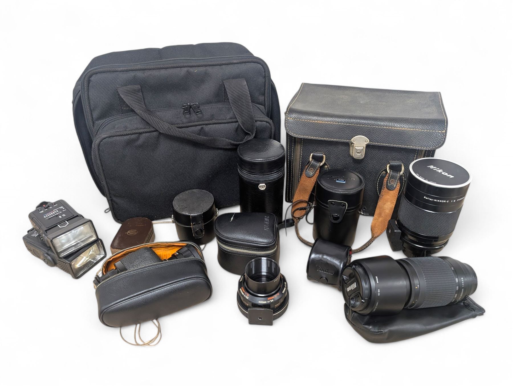 Kodak Dakon II folding camera and a collection of camera lenses and accessories, including Reflex-Nikkor  1:8 f=500mm, NikoN AF Nikkor 70-300mm 1:4-5.6G, Micro TM monocular lens and Teleshot adapter, two cases, Weston exposure meter, two cases etc