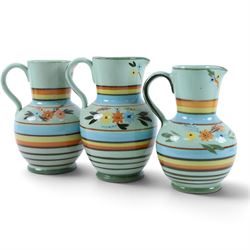 Hartrox Stoneware comprising three jugs, two vases and three bowls, all with green, blue and yellow floral decoration, with printed marks beneath, tallest H20cm