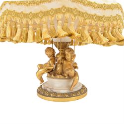 Onyx table lamp, of urn form with scrolling gilt handles, the stepped circular base adorned with three seated putti, H60cm