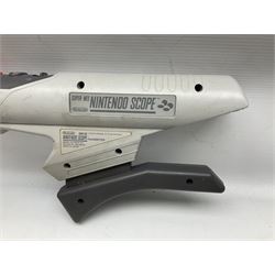 Two Super Nintendo Entertainment System (PAL) controllers, accessories and games. Super NES Game Commander with original box and instruction booklet, Super NES Nintendo Scope (1992) transmitter gun, receiver, Super NES Nintendo Scope 6 game with original instruction booklets. Further games to include ‘The Legend of Zelda a Link to the Past’, ‘Super Mario World’, ‘Super Mario Kart’, ‘The Lawnmower Man’, and ‘Exhaust Heat’, all with original instruction booklets. ‘PowerMonger’ and Disney’s ‘Aladdin’ game cartridges only 