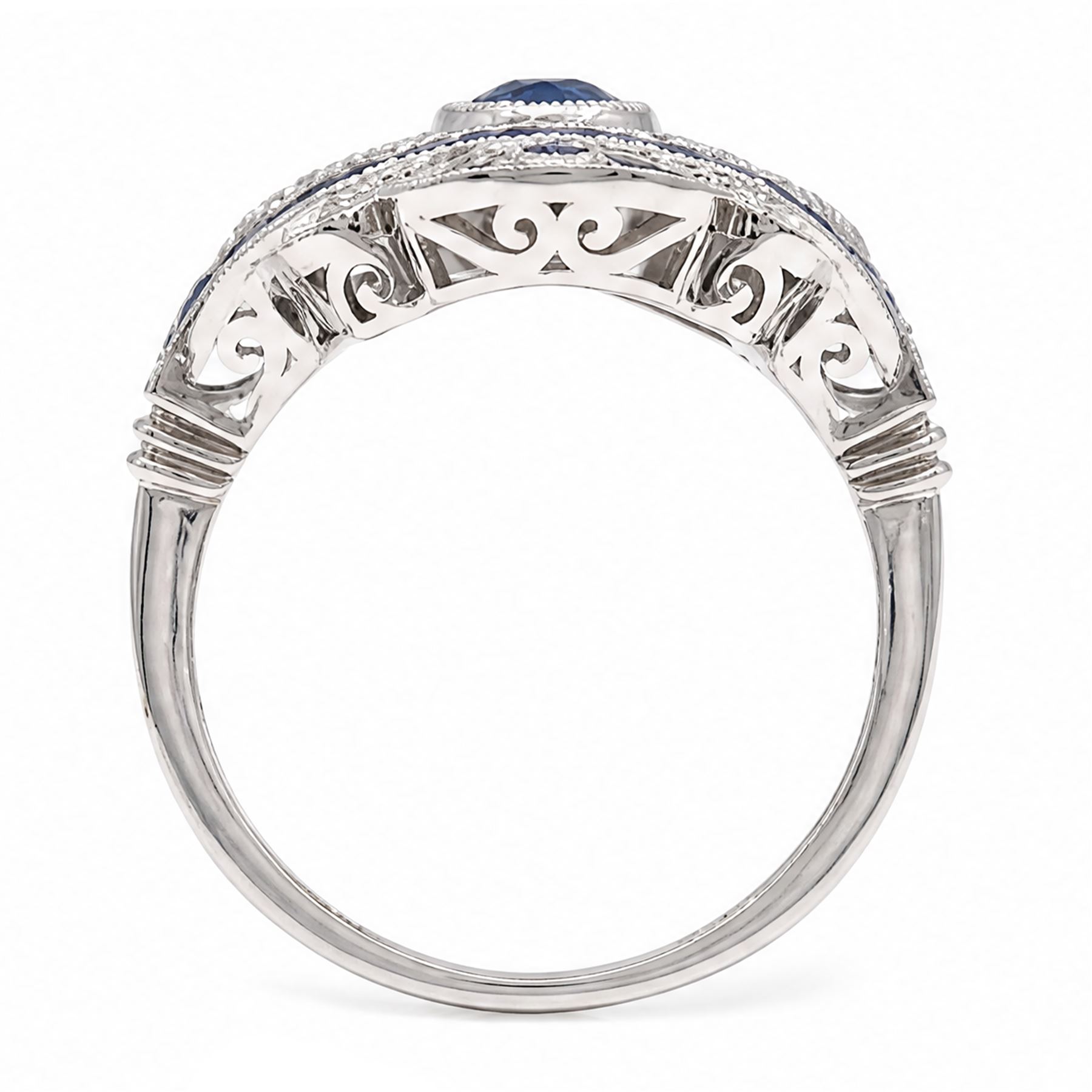 Platinum sapphire and diamond dress ring, milgrain set with a single oval cut sapphire, surrounded by single cut diamonds, calibre and vari-cut sapphires, in an pierced design setting, stamped PT 950, total sapphire weight 0.87 carat, total diamond weight 0.45 carat