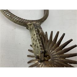 Pair of late 19th century South American iron spurs, engraved silver mounts, with sunburst rowls
