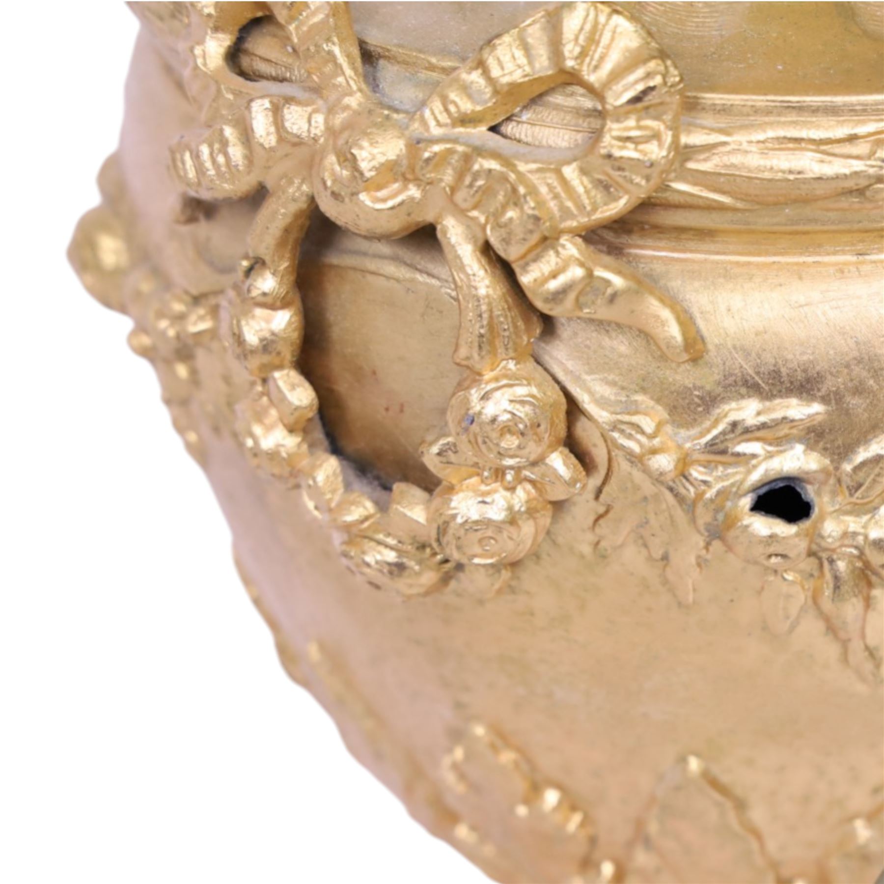 Pair of Rococo style gilt metal table lamps, the urn shaped bodies each with applied figure seated upon shoulder, and female mask to opposite side issuing scroll leading to top of neck, the body cast and applied with stiff leaf detail, and foliate swags and wreaths, upon square pink marble plinths with applied gilt metal mask mounts, and four gilt metal bracket feet, each supported a pleated cream silk closed top lampshade, H63cm