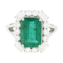 18ct white gold emerald and diamond cluster ring, single octagonal cut emerald of approx 2...