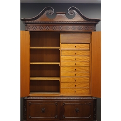  Early 20th century mahogany Chippendale style cabinet, carved swan neck pediment above blind fretwork frieze and acanthus carved moulding, two doors enclosing three shelves and a bank of nine drawers with fitted cutlery inserts, below two doors enclosing  shelf, scroll carved apron, cabriole legs with ball and claw feet, W126cm, H208cm  