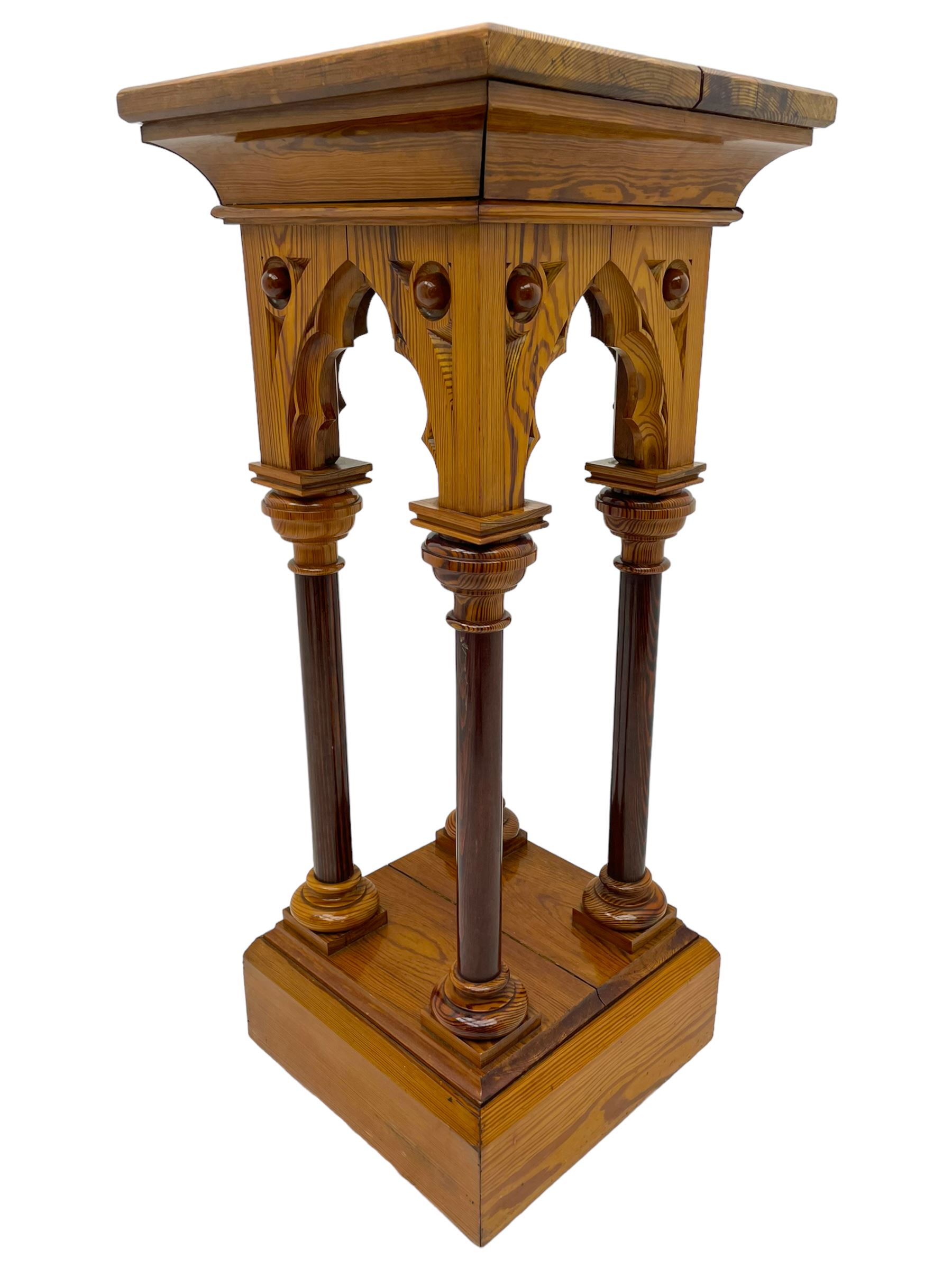 19th century pitch pine ecclesiastical pedestal stand, the square chamfered top over cusped Gothic pointed arches and four turned column supports, stepped and moulded plinth base