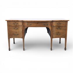 Early 20th century mahogany bow front sideboard, the shaped and moulded top above central kneehole recess with baize lined frieze drawer, flanked by twos drawers either side with the lower drawer double height, raised upon square tapering legs with spade feet