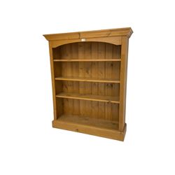 Pine open bookcase, fitted with three shelves flanked by fluted uprights, on plinth base