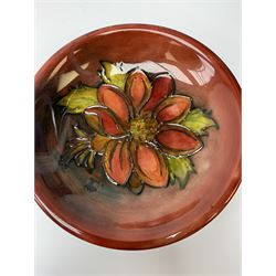 A Moorcroft flambe dish, circa 1950, decorated in the Clemmatis pattern, marks beneath obscured by glued on fabric hanger, D19cm. 