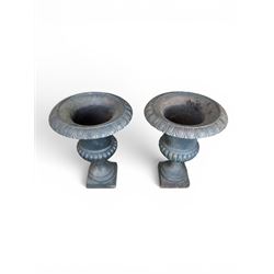 Pair of Victorian design heavy cast iron garden urns, black painted, egg and dart rim on waisted column