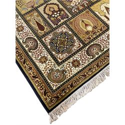 Persian design carpet, the field with various size tiles decorated with stylised plant motifs, floral urns and peacocks, the main border decorated with repeating foliate motifs and trailing flower heads